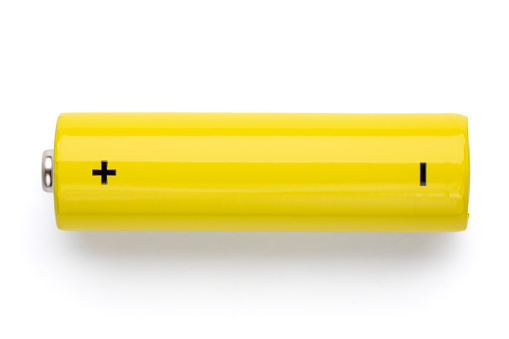 Top view of yellow AA alkaline battery (Mignon) or NiMH rechargeable cell on white background