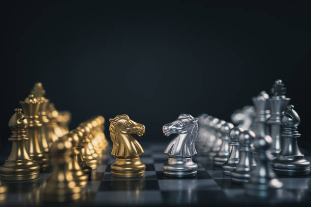 istock Close-up of gold and silver team chess board game 1191651625