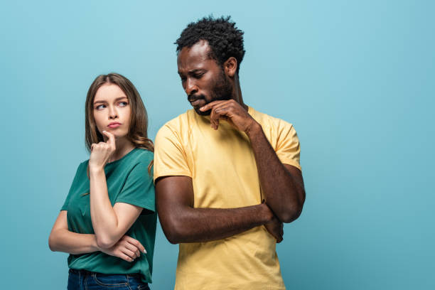 istock thoughtful interracial couple on blue background 1191653614