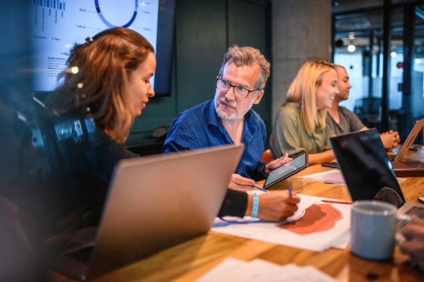 istock Business Colleagues Discussing Point in Office Board Room 1191653726