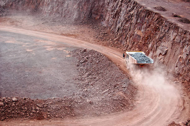 istock Dumper truck with rock material driving through mine. 1191654866