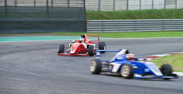 istock Drivers driving racing car 1191655592