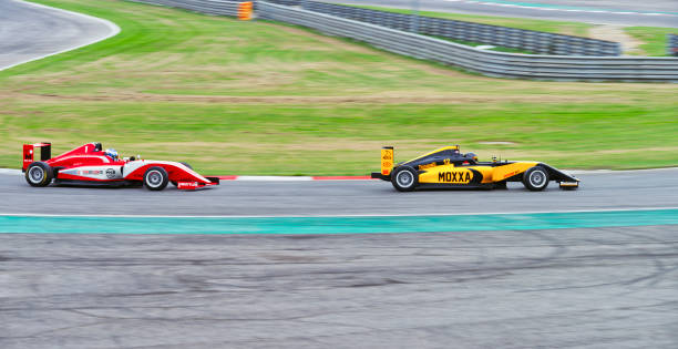 istock Drivers driving racing car 1191655605