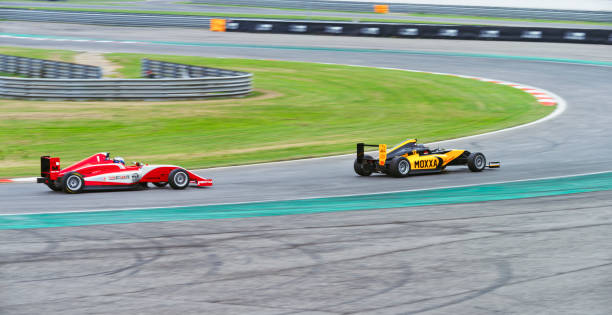 istock Drivers driving racing car 1191655610