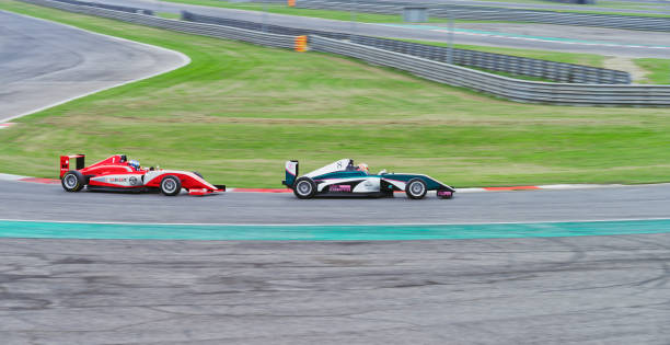 istock Drivers driving racing car 1191655618