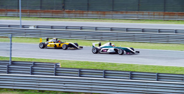 istock Drivers driving racing car 1191655626