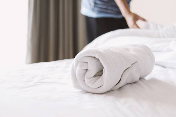 istock towel on white bed with a man making a bed 1191656194