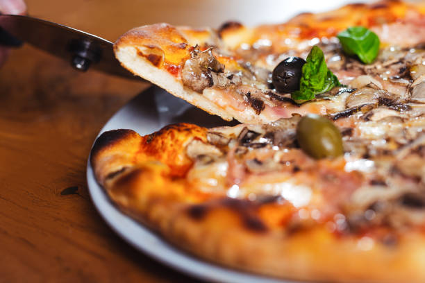 istock Delicious italian pizza served on wooden table 1191657025