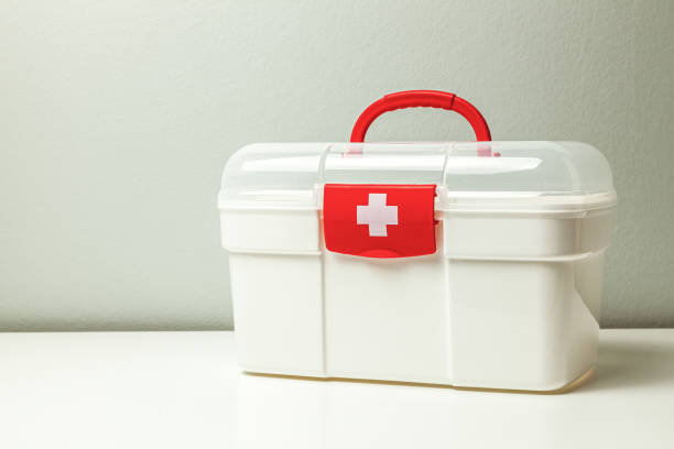 istock First Aid Kit. White box with a cross and a red clasp on a gray background 1191658693