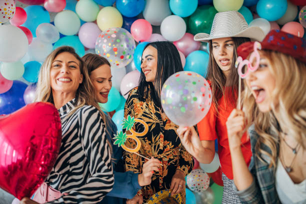 istock Young ladies having fun with balloons 1191661262