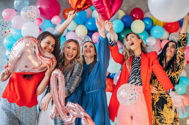 istock Happy ladies having fun with balloons 1191661406