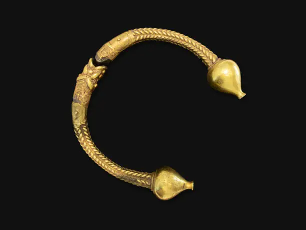 Antique golden bracelet called torc isoled on black background. Rigid neck ring or bracelet from Celts. Circa 1st to 2nd century BC. Galicia, Spain