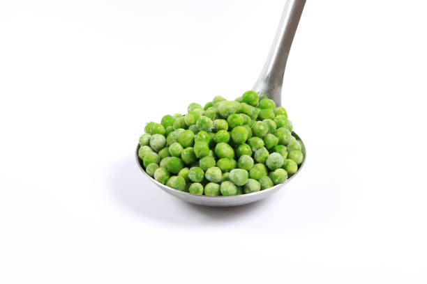 istock Frozen vegetables Green Peas on white background awaiting preparation for cooking 1191665543