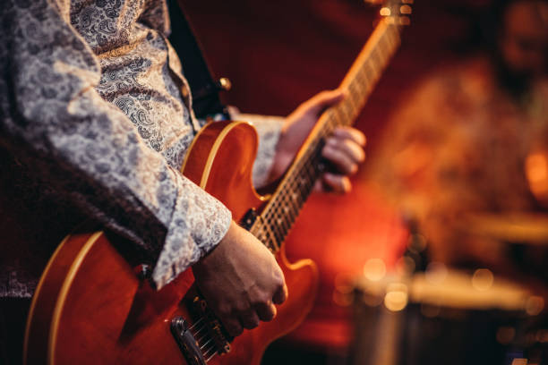 istock Man playing electric guitarist on stage 1191669380