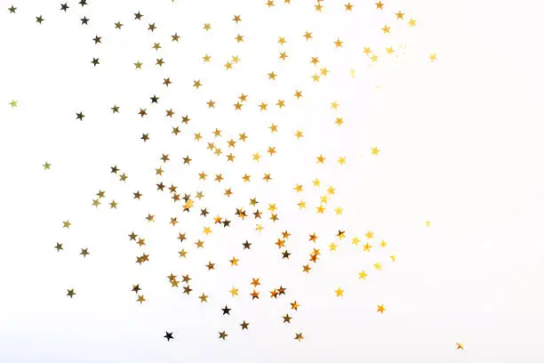 Golden stars on white background. Flat lay, top view.