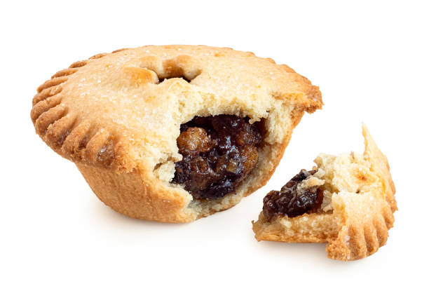 istock Broken open traditional british christmas mince pie with fruit filling isolated on white. 1191671957