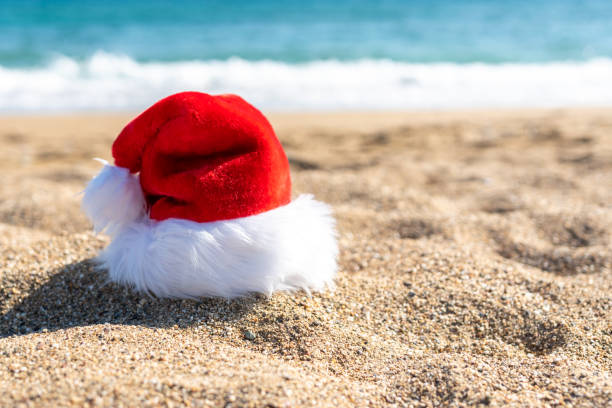 istock Santa Claus hat on sandy beach. Creative Christmas or New Year concept. 1191672124