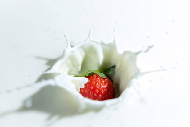 istock Raw strawberry falling into milk with splashes. 1191672144