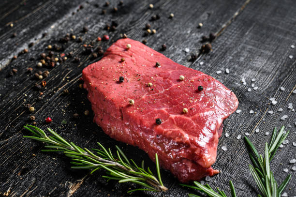 istock Raw new York strip steak. Beef meat. Black background. Top view. 1191672420