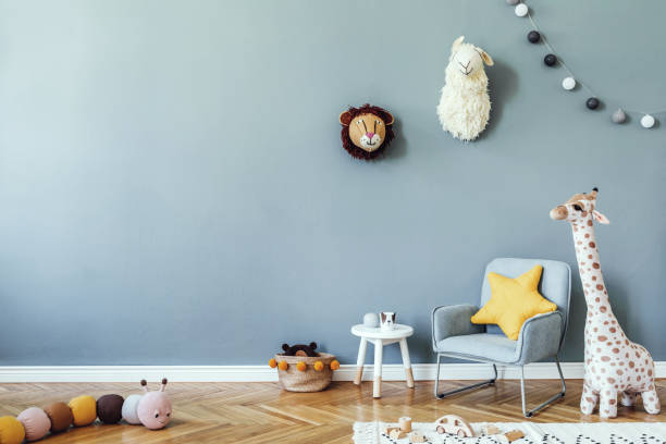 Stylish scandinavian kid room with toys, teddy bear, plush animal toys, mint armchair, cotton balls. Modern interior with eucalyptus background walls, Design interior of childroom. Template Stylish scandinavian kid room. Design interior of childroom. Template Home decor concept. kid goat stock pictures, royalty-free photos & images