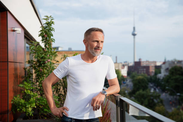 istock Handsome man standing on a balcony in Berlin, Germany 1191675247