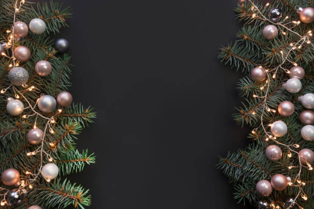 istock Christmas frame with fir branches, red balls, garland on black background. Space for text, view from above, flat lay. 1191676908
