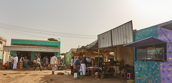 Khartoum, Sudan, ca. February 8., 2019: Marketplace with people shopping in a village in the desert