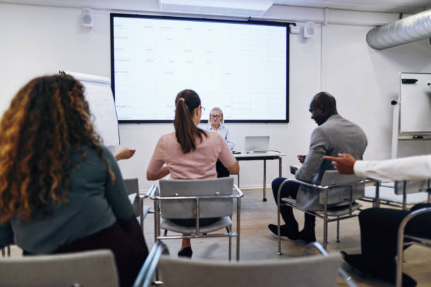 istock Manager giving a projection screen presentation to office staff 1191681610
