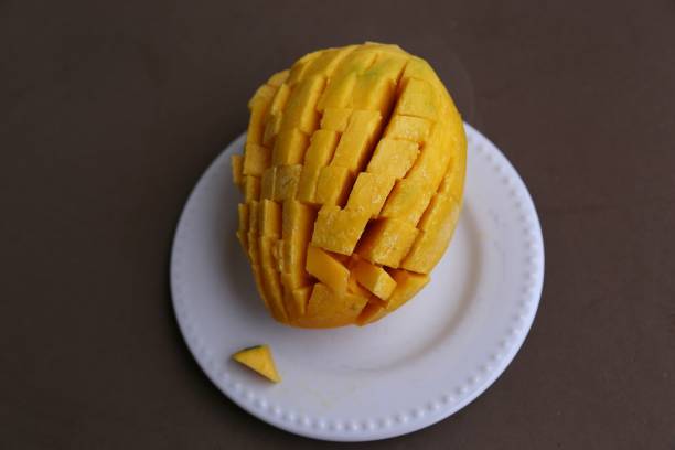 istock Large sugar tropical mango fruit with no skin ready to eat on a white plate view from above 1191681671