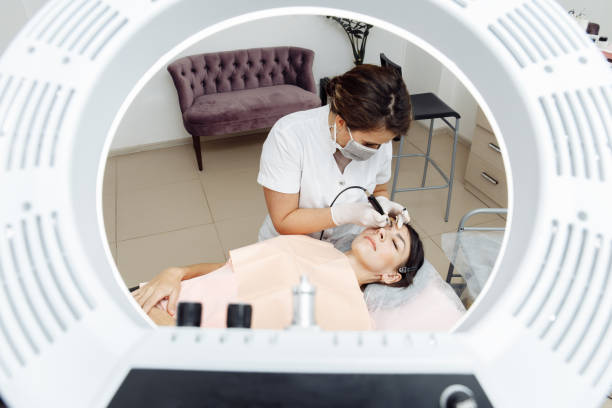 istock Permanent makeup, tattooing of eyebrows. Cosmetologist applying make up 1191681959