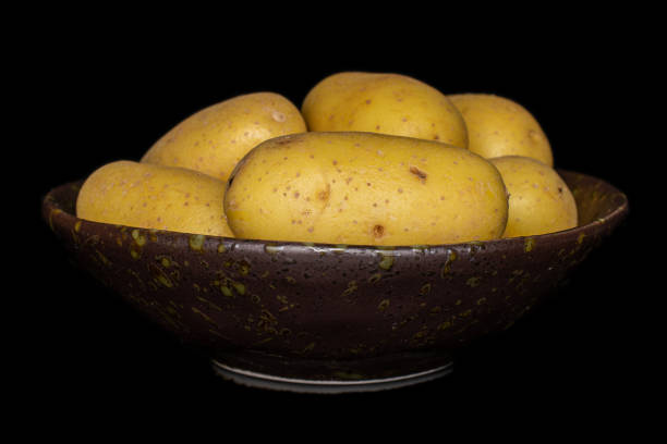 Raw potatoes in a basket for cooking isolated on white background