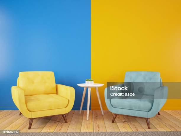 Armchairs Divided In Half Into Two Parts In The Middle Yellow Blue Modern And Colorful Cozy Concept Stock Photo - Download Image Now
