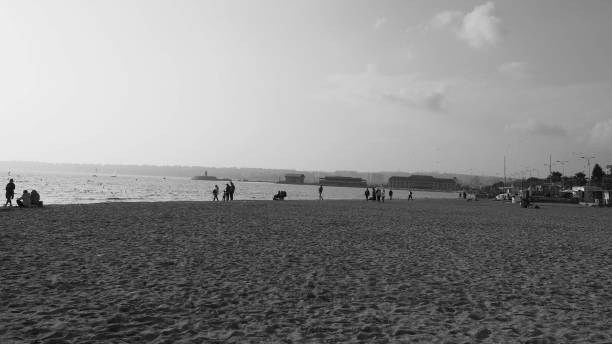 istock Sea and people walking on sand 1191682385