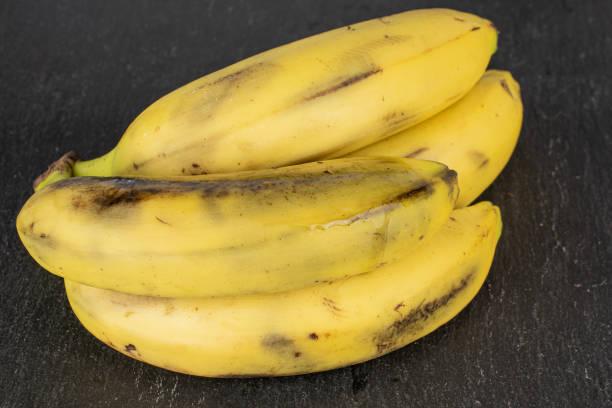 istock Sweet yellow banana on grey stone 1191682570