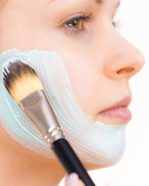 istock Girl apply green mud mask to face 1191683385