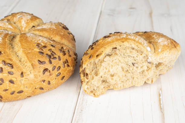 istock Sesame kaiser roll on grey wood 1191683669
