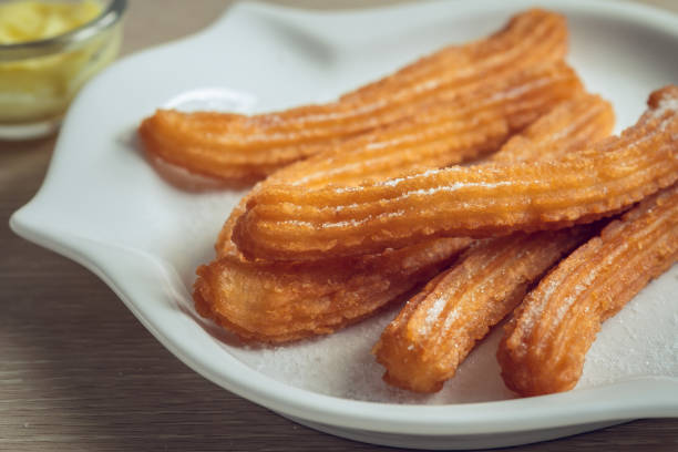 istock Churros with sugar on plate and cheese dip 1191683732