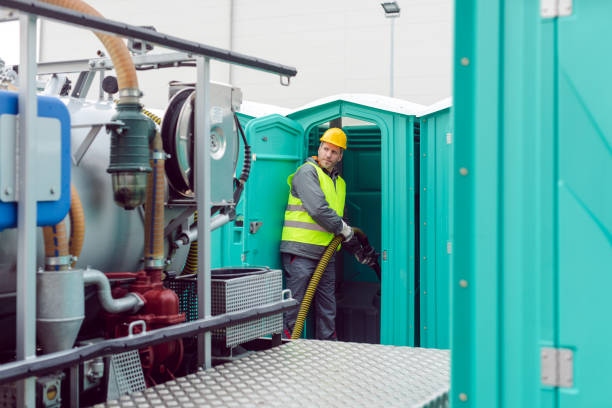 Worker pumping feces out of rental toilet for disposal Worker pumping feces out of rental toilet for disposal and cleaning portable toilet stock pictures, royalty-free photos & images