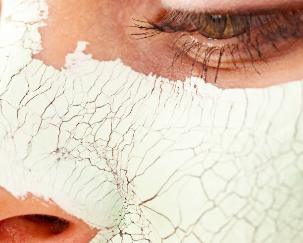 istock Girl with mud mask on face 1191685703