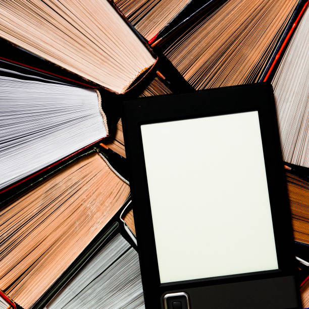 istock The e-book with a clean white screen rests on the open multi-colored books. ready to read 1191686798