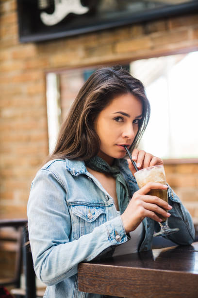 istock Smiling woman drinking beer 1191687578