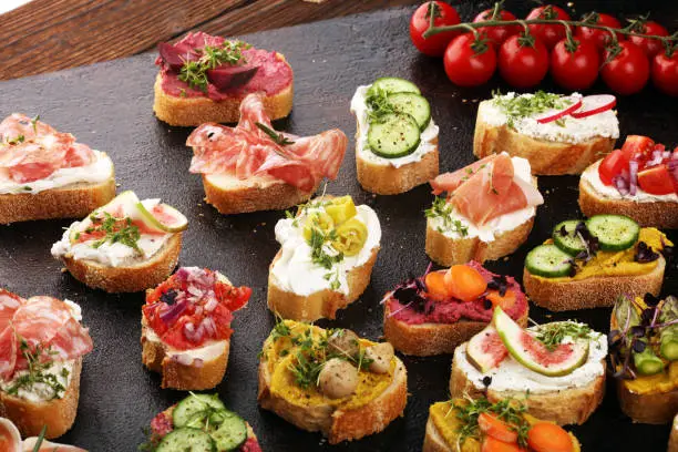 Assorted bruschetta with various toppings. Appetizing bruschetta or brie crostini. Variety of small sandwiches. Mix bruschetta
