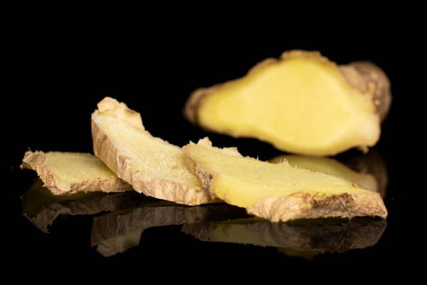 istock Fresh brown ginger isolated on black glass 1191688765