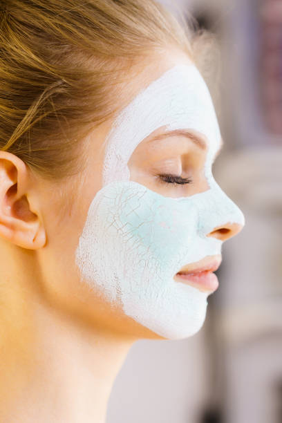 istock Girl with green mud mask on face 1191688766