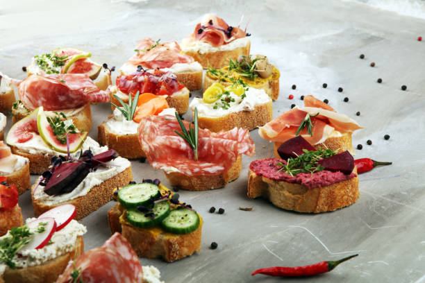 istock Assorted bruschetta with various toppings. Appetizing bruschetta or brie crostini. Variety of small sandwiches. Mix bruschetta on table 1191688820