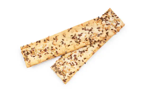 Studio shot of multi seed flatbread cut out against a white background.