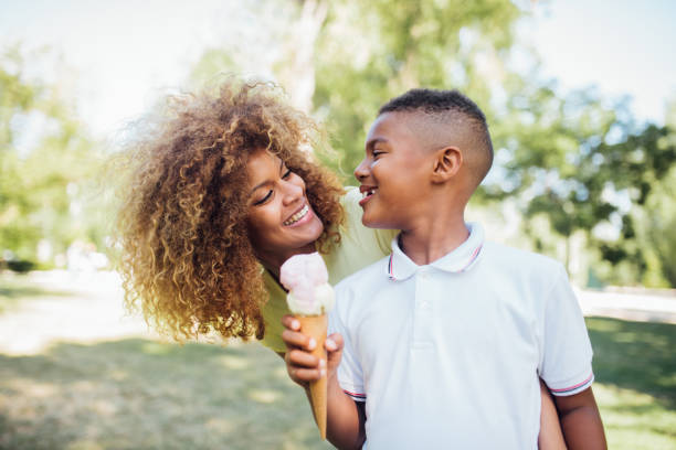 istock Cute boy eating ice cream and having fun with mom 1191690658