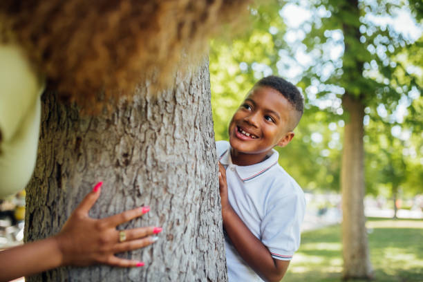 istock Boy playing a hiding game in the park with his mother 1191690665
