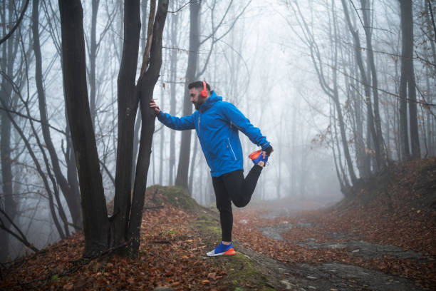 istock Man Running In The Forest. 1191691881