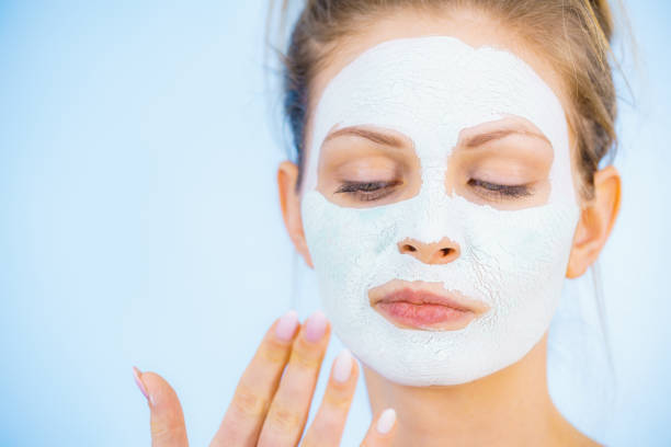 istock Girl with dry white mud mask on face 1191693017